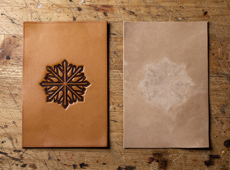 Two leather samples side by side after laser engraving showing dark high contrast on vegetable tanned leather and uneven gray marking on chrome tanned leather