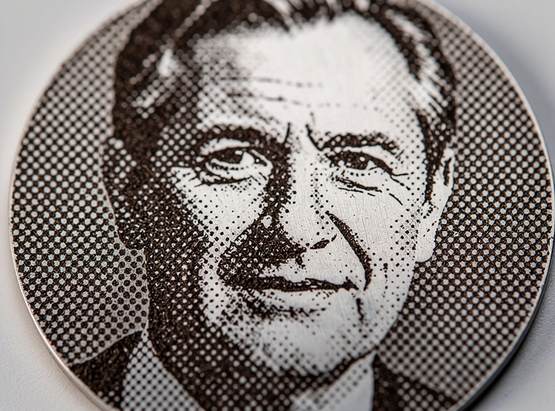 Close-up macro of laser-engraved portrait showing Floyd-Steinberg dithering pattern