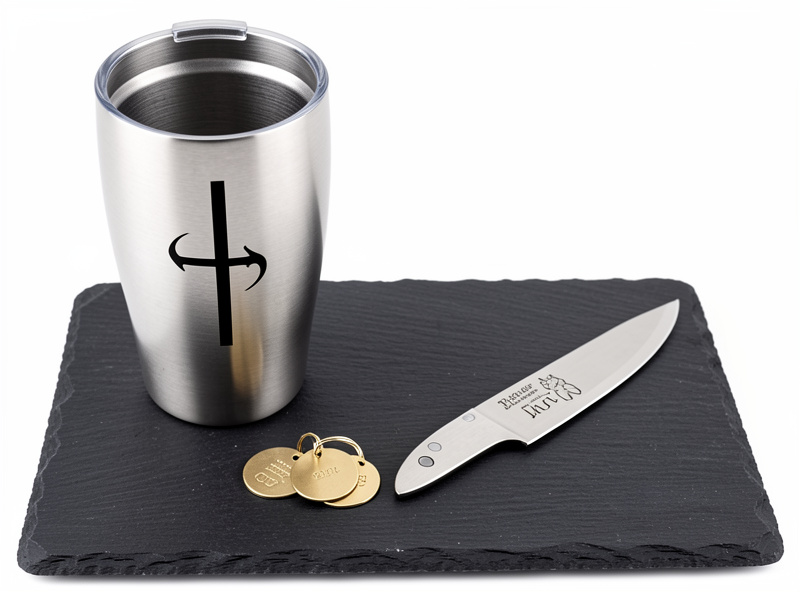 Fiber laser engraved metal products including a stainless steel tumbler, brass pet tags and a marked knife blade
