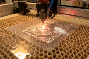 Laser cutting a detailed stencil pattern into a thin mylar sheet on the honeycomb bed