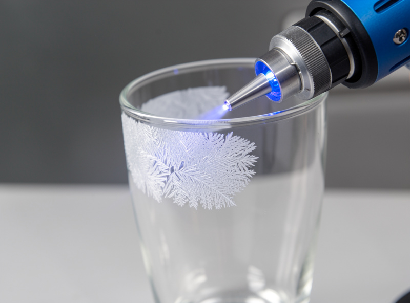 Diode laser frosting a drinking glass with air assist running on the workshop bench