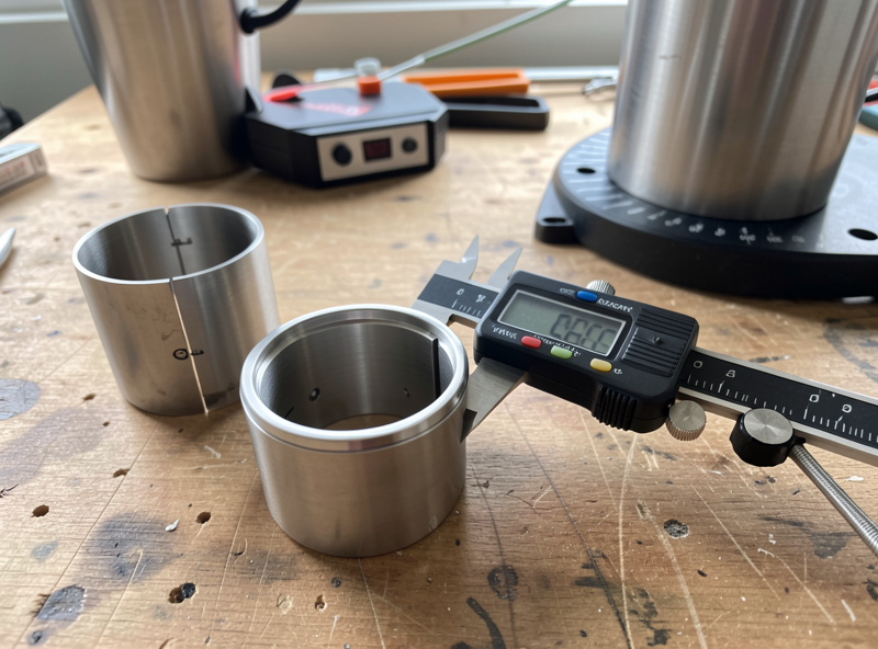 Caliper measuring the engraving band diameter of a stainless tumbler before a rotary laser job